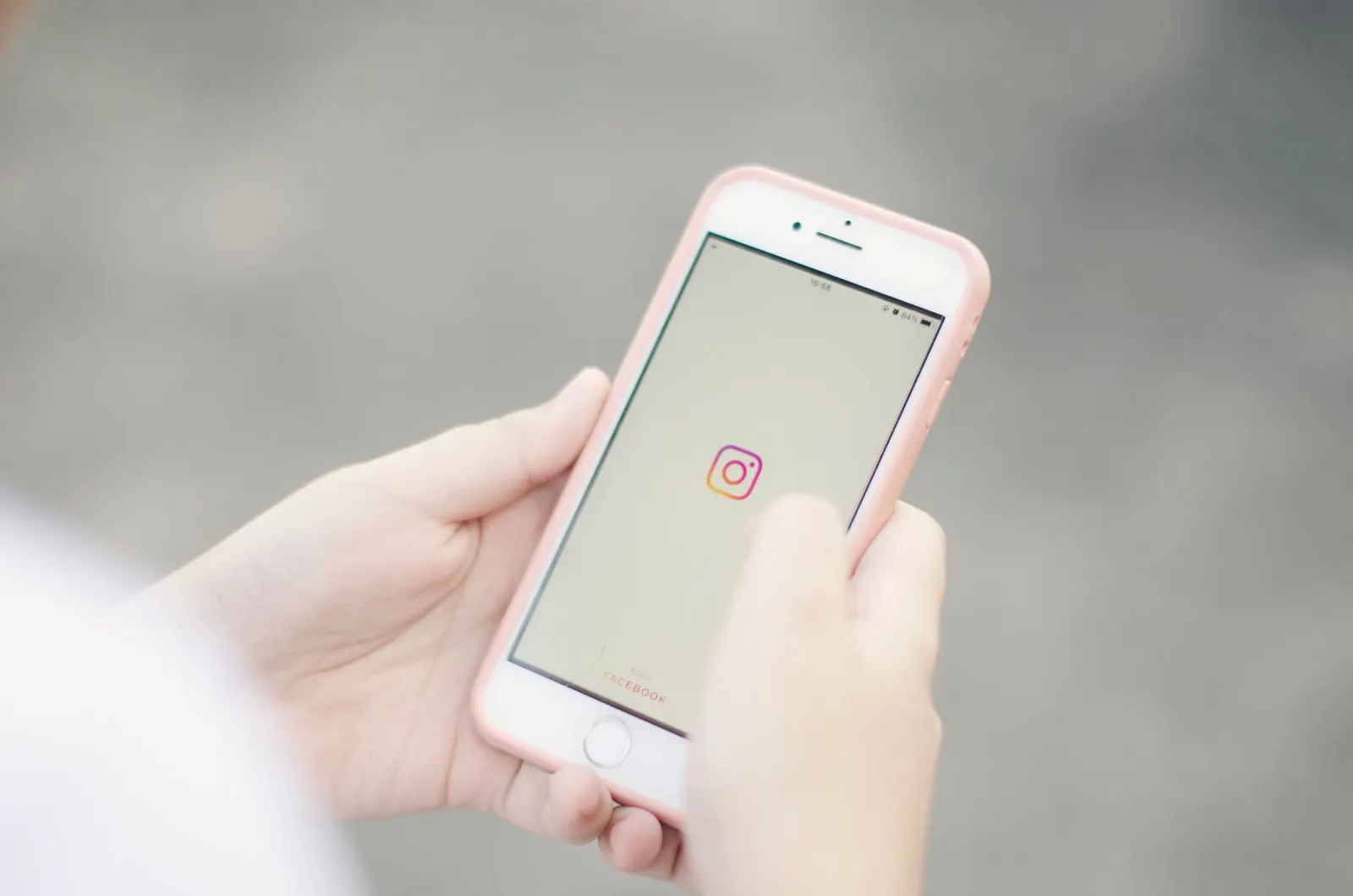Hands holding a smartphone with a blurred light background, representing customer app messages